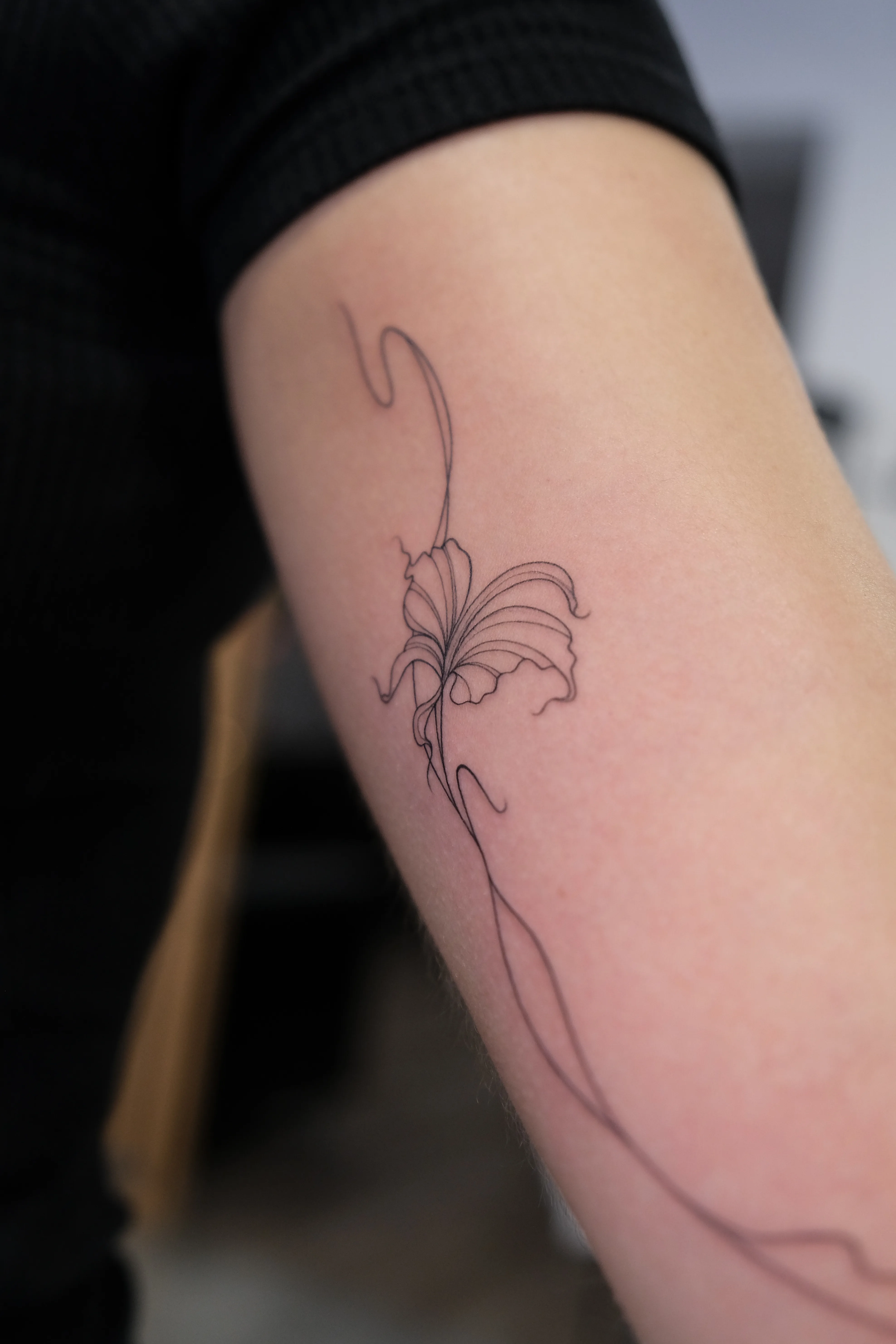 Fine line floral tattoo