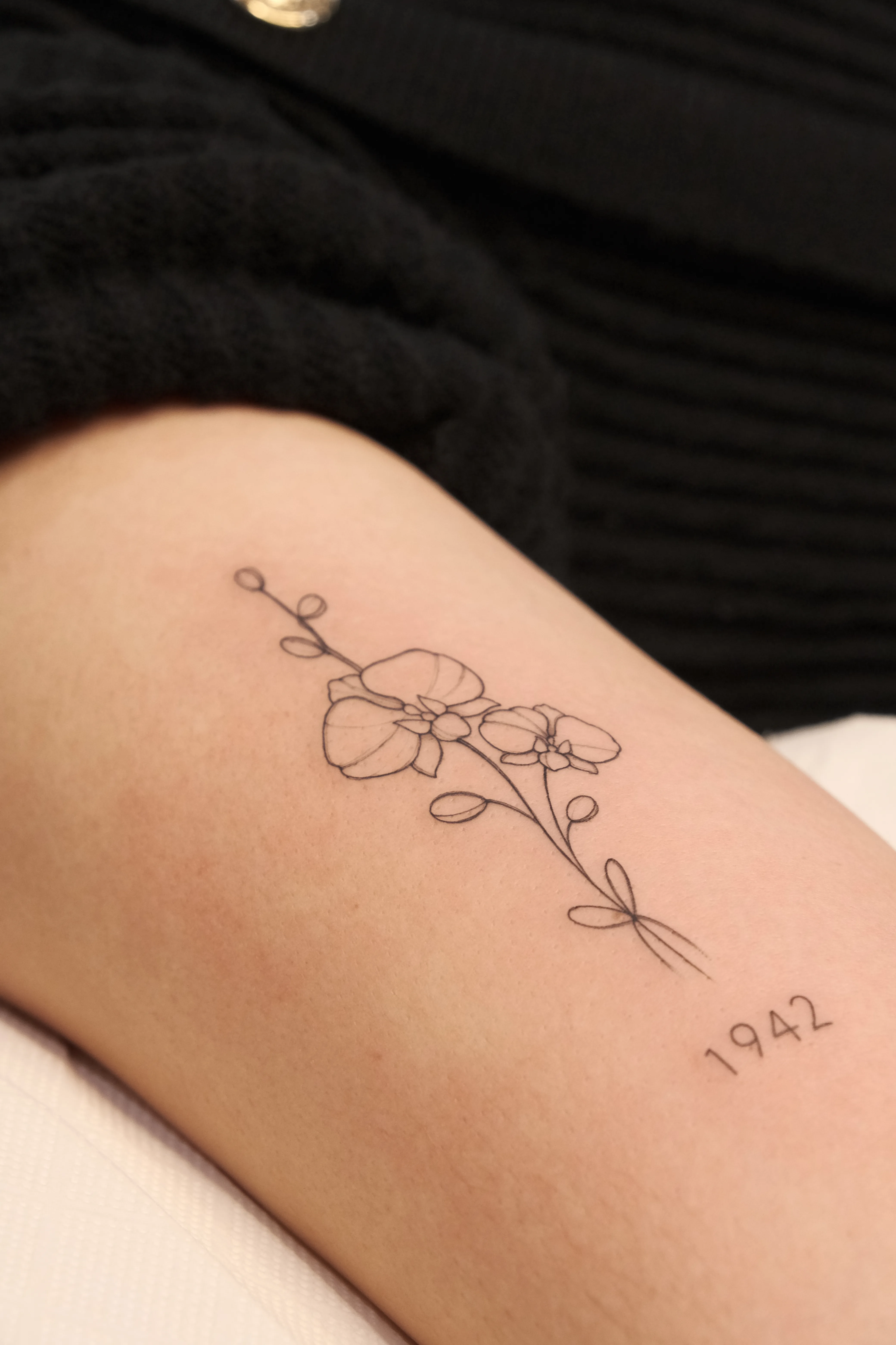 Fine line floral tattoo