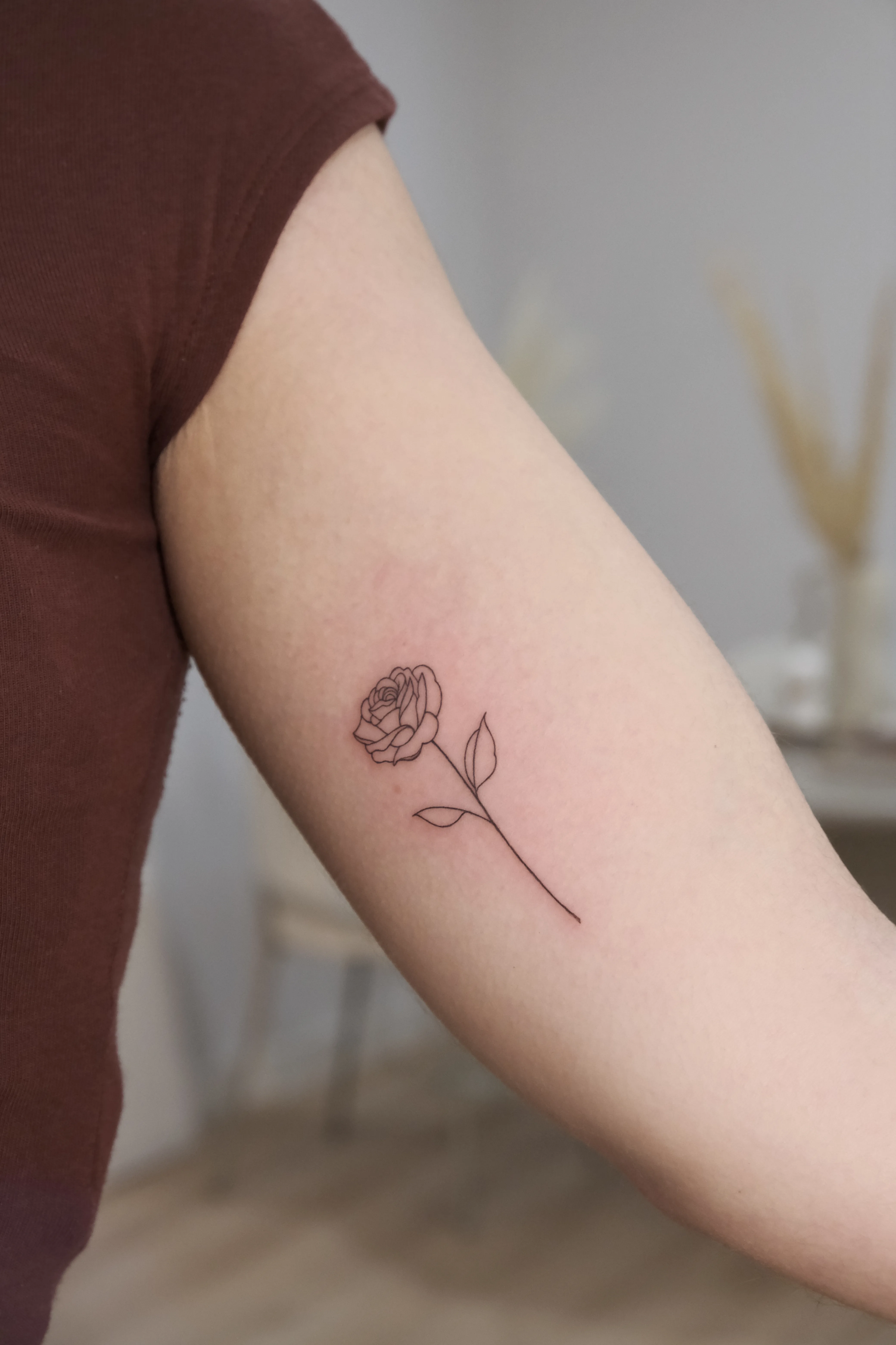 Fine line floral tattoo